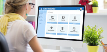 Woman working with human resources software on computer